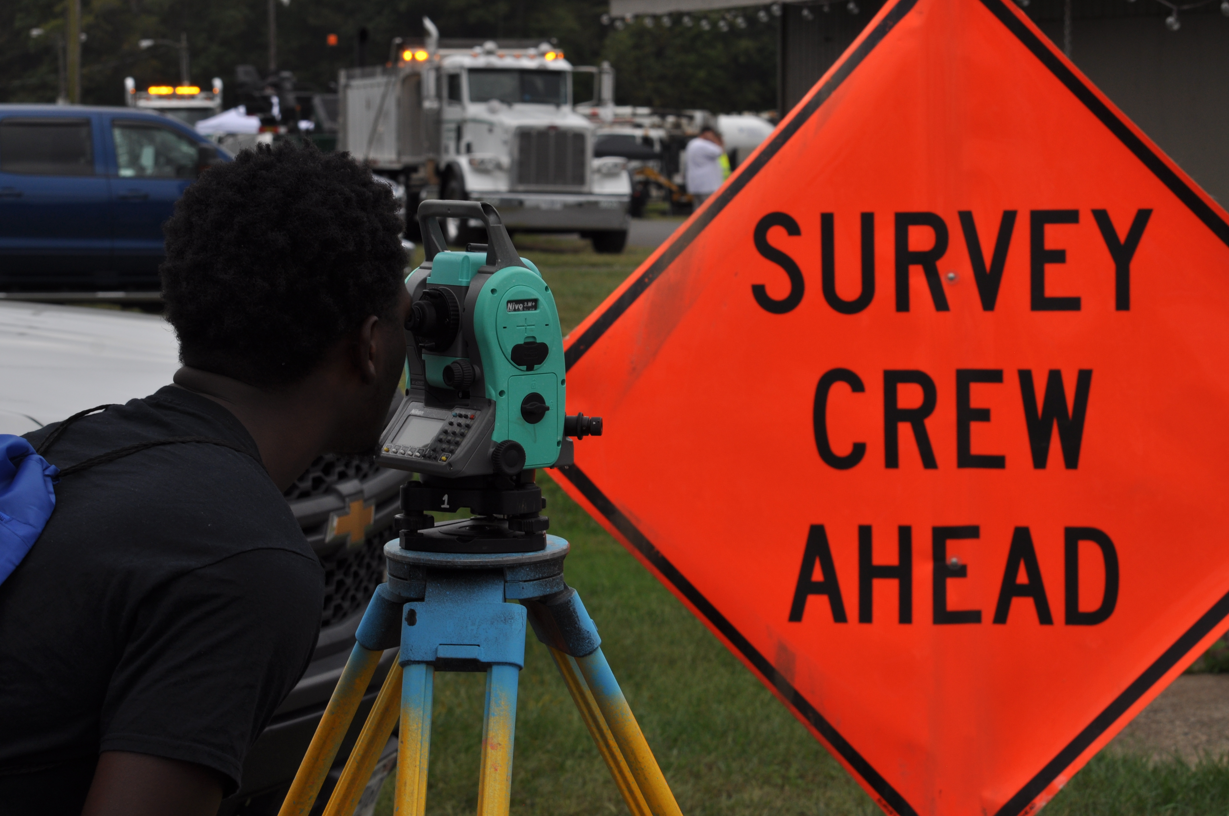 A student tries out surveying equipment at the 2019 Career Fair